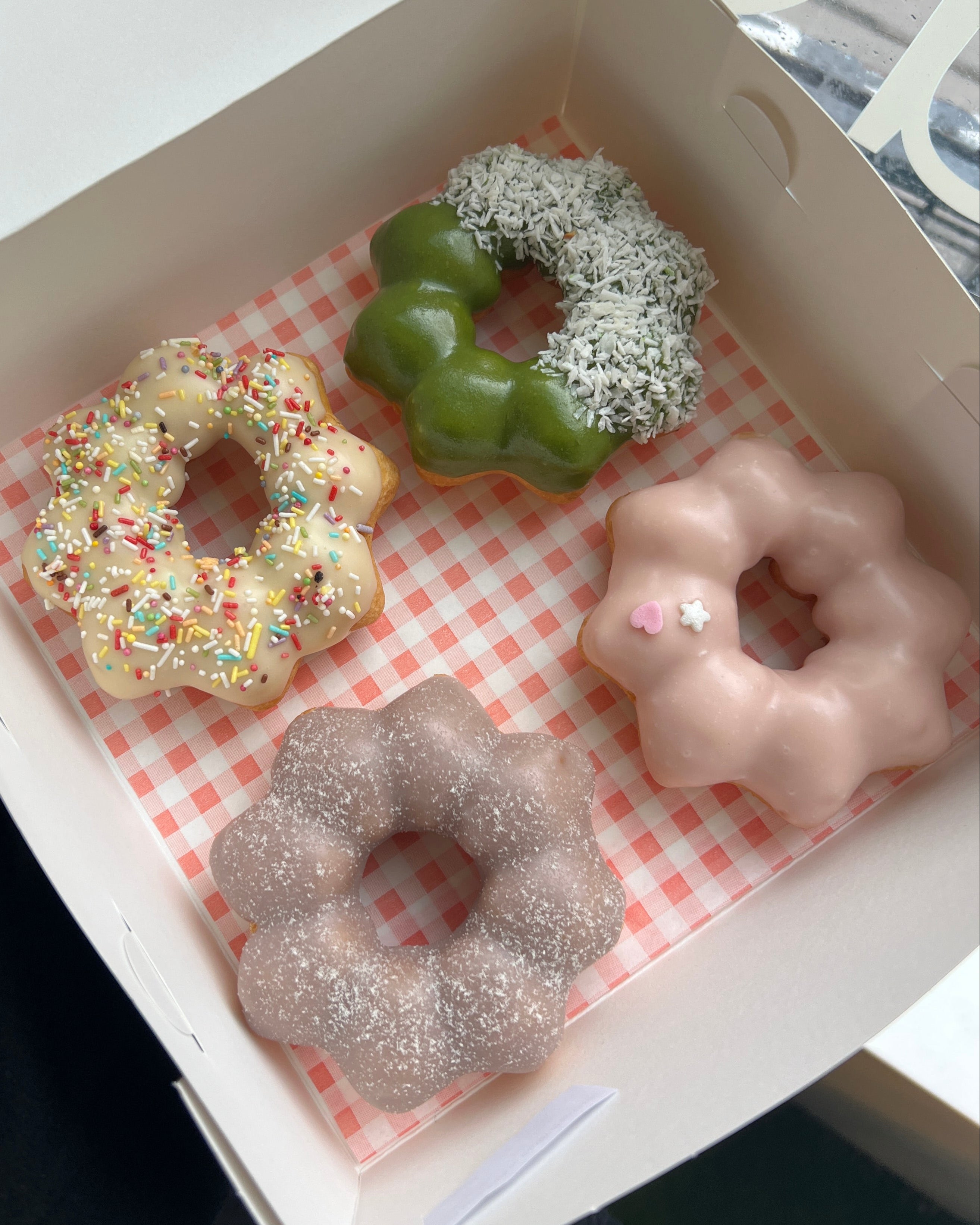 A box of chewy mochi donuts with panda, birthday cake, blueberry, and strawberry flavours