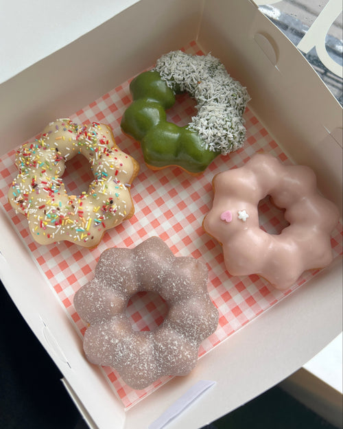 A box of chewy mochi donuts with panda, birthday cake, blueberry, and strawberry flavours